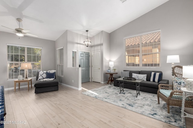 5305 N Via Ln, Doncella, Tucson, AZ 85750 - living area featuring wood finished floors, baseboards, a ceiling fan, high vaulted ceiling, and a chandelier