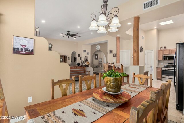 dining area featuring arched walkways, ceiling fan with notable chandelier, recessed lighting, and visible vents
