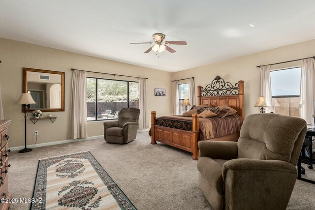 bedroom with light colored carpet, a ceiling fan, and baseboards