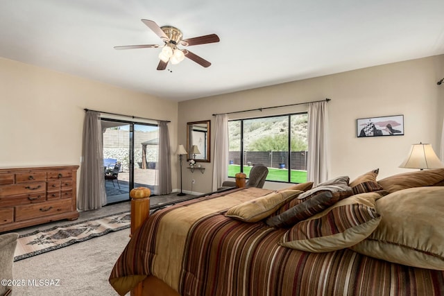 bedroom with carpet flooring, ceiling fan, multiple windows, and access to exterior