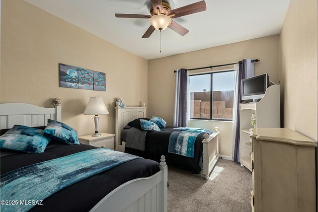 bedroom with ceiling fan and light carpet