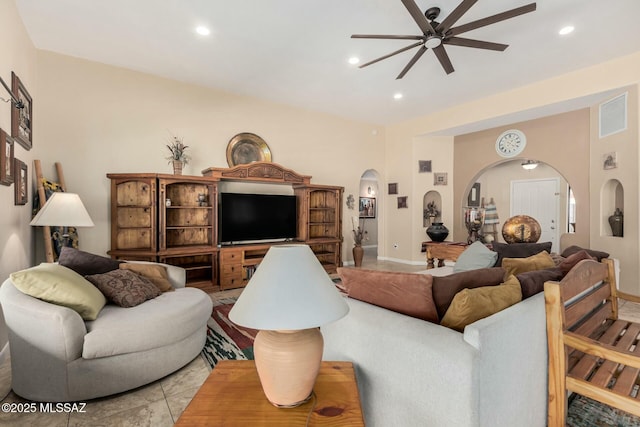 living room featuring recessed lighting, arched walkways, baseboards, and a ceiling fan