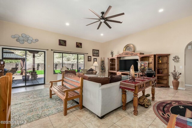 living room with recessed lighting, a ceiling fan, arched walkways, and light tile patterned floors