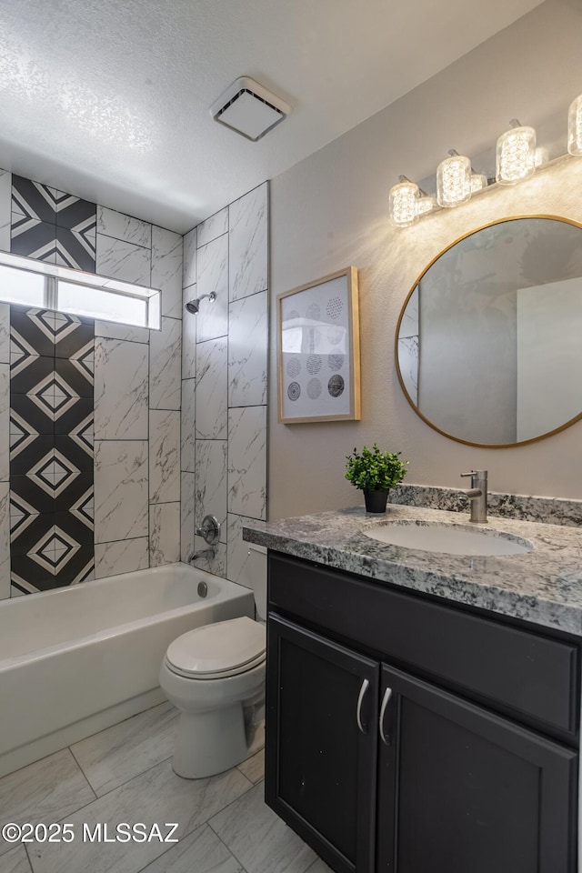 bathroom with marble finish floor, toilet, shower / tub combination, vanity, and a textured ceiling