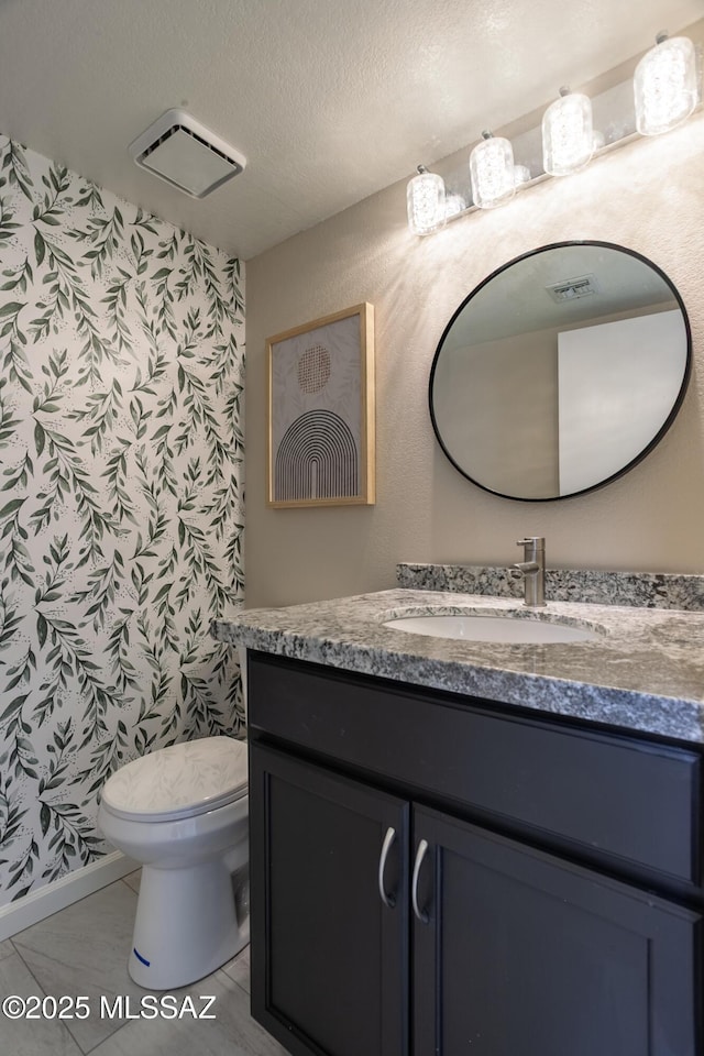 bathroom with visible vents, wallpapered walls, toilet, and vanity