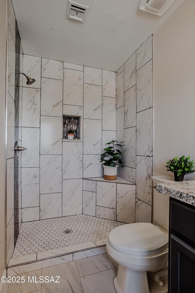 full bath with visible vents, a stall shower, toilet, vanity, and marble finish floor