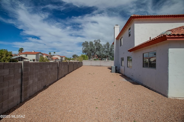view of yard featuring a fenced backyard and central AC unit
