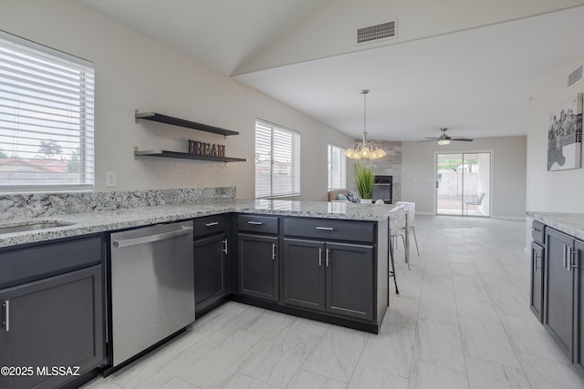 kitchen with stainless steel dishwasher, ceiling fan with notable chandelier, visible vents, a peninsula, and open floor plan