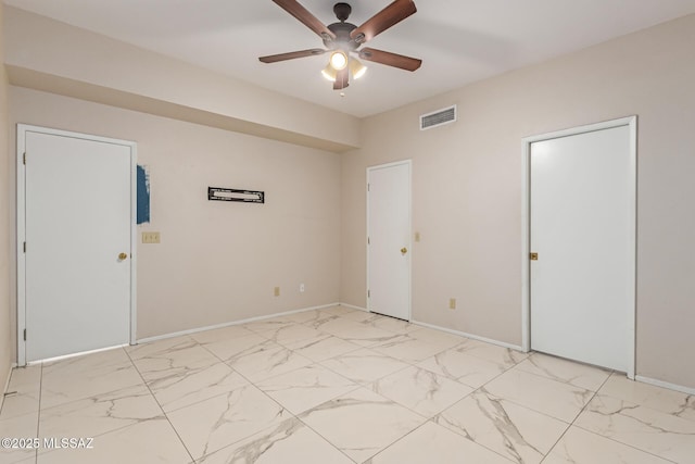 empty room featuring baseboards, a ceiling fan, marble finish floor, and visible vents