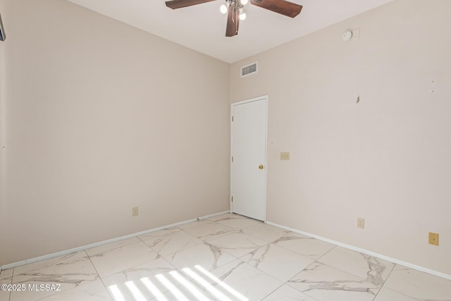 unfurnished room with a ceiling fan, baseboards, visible vents, and marble finish floor