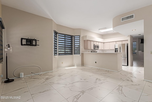kitchen featuring appliances with stainless steel finishes, light countertops, a peninsula, baseboards, and visible vents