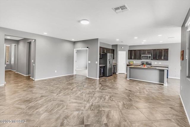 3156 S Three D Ct, Tucson, AZ 85713 - unfurnished living room featuring baseboards and recessed lighting