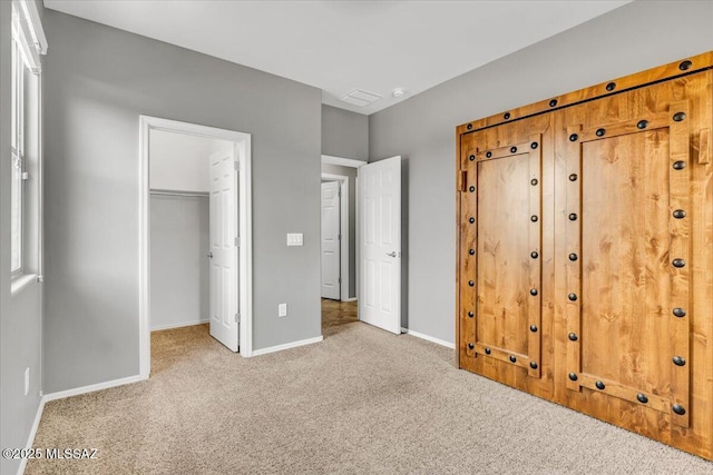 3156 S Three D Ct, Tucson, AZ 85713 - unfurnished bedroom featuring carpet flooring, baseboards, a walk in closet, and a closet