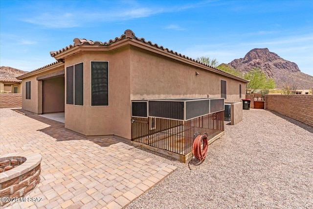3156 S Three D Ct, Tucson, AZ 85713 - rear view of house with a mountain view, stucco siding, and a fenced backyard