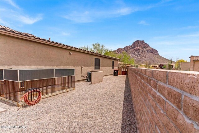 3156 S Three D Ct, Tucson, AZ 85713 - view of side of property featuring a mountain view, stucco siding, and fence