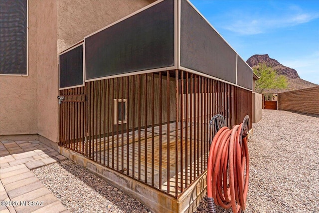 3156 S Three D Ct, Tucson, AZ 85713 - view of side of property with stucco siding, a mountain view, and fence