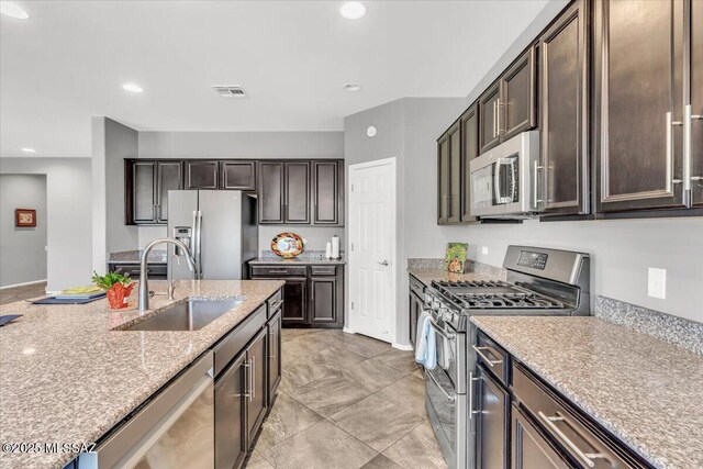 3156 S Three D Ct, Tucson, AZ 85713 - kitchen featuring appliances with stainless steel finishes, a sink, dark brown cabinets, and recessed lighting