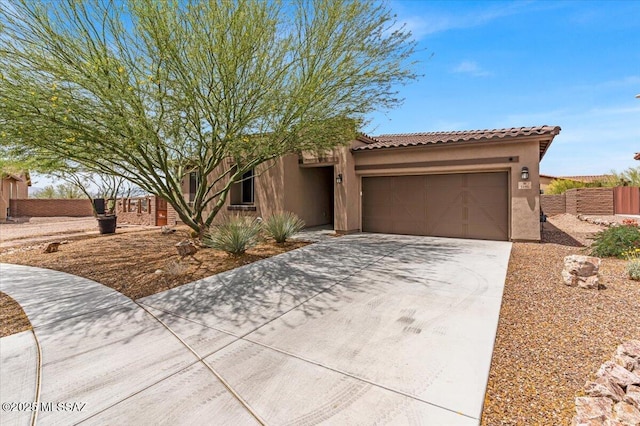 3156 S Three D Ct, Tucson, AZ 85713 - view of front of home with stucco siding, an attached garage, a tiled roof, driveway, and fence