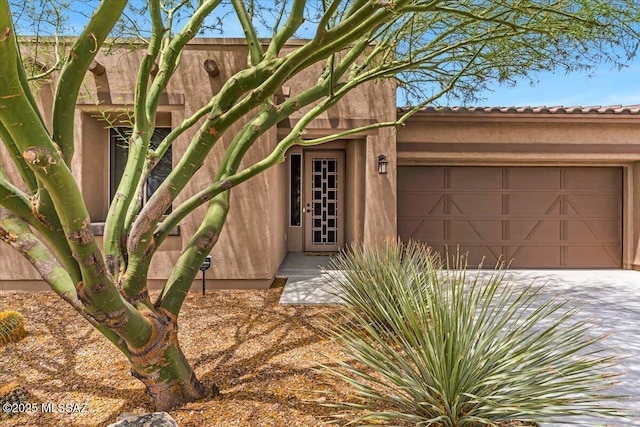 3156 S Three D Ct, Tucson, AZ 85713 - view of exterior entry featuring an attached garage and driveway