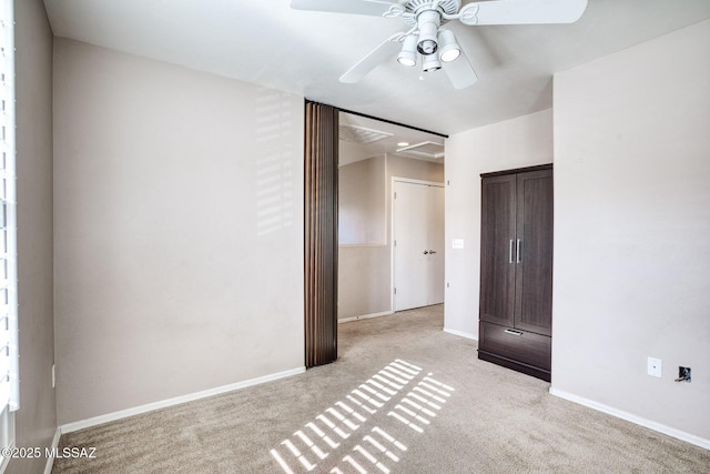 unfurnished bedroom with baseboards, a ceiling fan, and light carpet