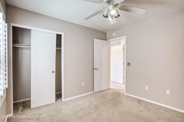 unfurnished bedroom with baseboards, carpet, and a closet