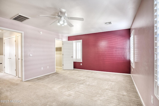 unfurnished bedroom with baseboards, visible vents, and carpet