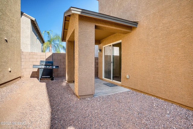 exterior space featuring a patio, stucco siding, and fence