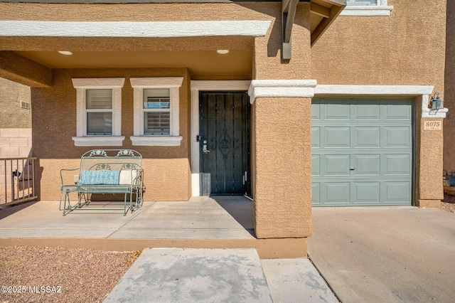 doorway to property featuring stucco siding