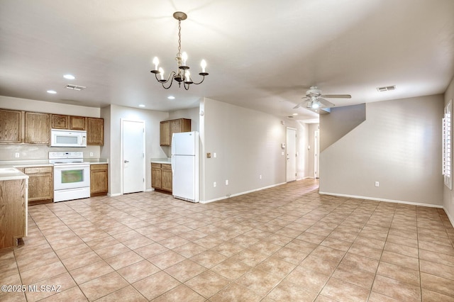 kitchen featuring white appliances, light countertops, brown cabinetry, recessed lighting, and open floor plan