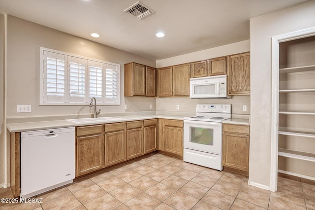 kitchen featuring visible vents, white appliances, recessed lighting, light countertops, and a sink