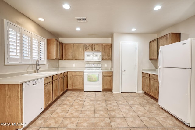 kitchen with a sink, white appliances, light countertops, recessed lighting, and visible vents