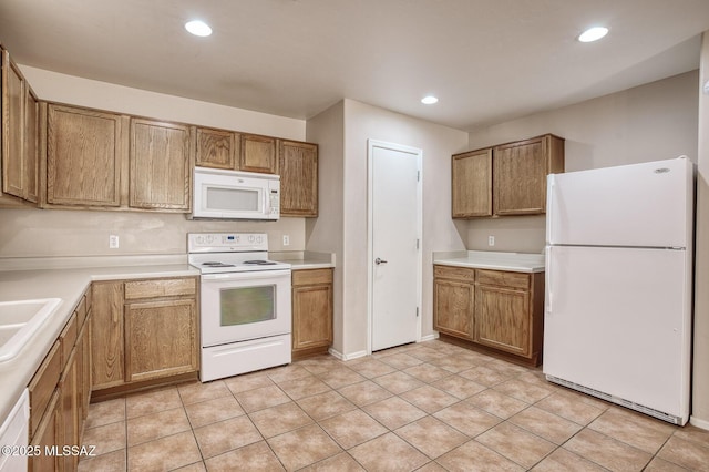 kitchen with recessed lighting, light countertops, brown cabinetry, and white appliances