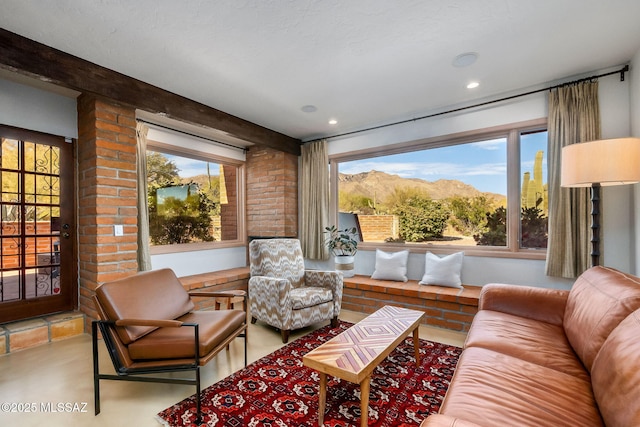 living room featuring a mountain view, recessed lighting, and finished concrete floors