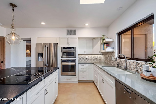kitchen with visible vents, appliances with stainless steel finishes, hanging light fixtures, open shelves, and a sink