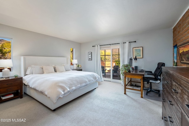 bedroom featuring light colored carpet and access to exterior