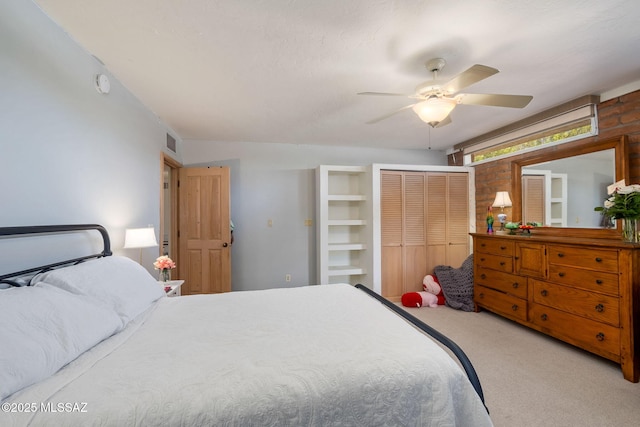bedroom with a closet, ceiling fan, carpet flooring, and visible vents