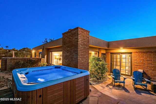 view of patio / terrace with a hot tub