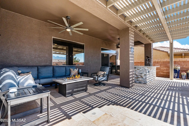 view of patio / terrace with an outdoor living space with a fire pit, a pergola, ceiling fan, and fence