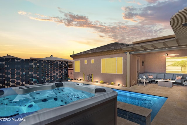 view of swimming pool with outdoor lounge area, a hot tub, and a patio