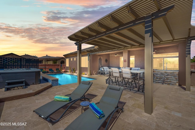 view of swimming pool with a hot tub, a patio area, outdoor dining space, ceiling fan, and a fenced in pool