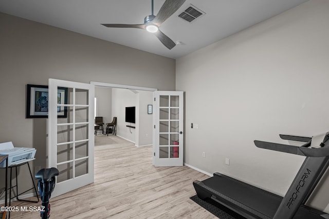 exercise area featuring french doors, wood finished floors, visible vents, ceiling fan, and baseboards