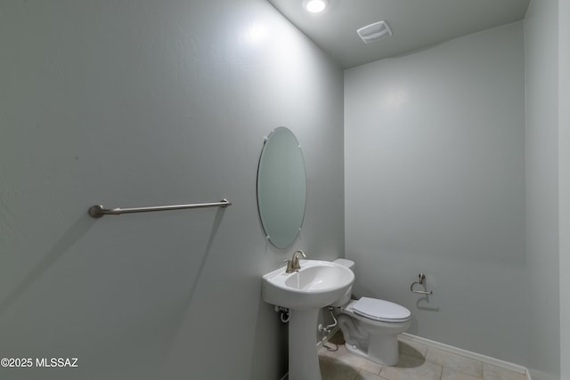 bathroom featuring tile patterned flooring and toilet