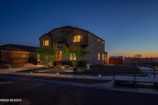 mediterranean / spanish house featuring stucco siding and fence