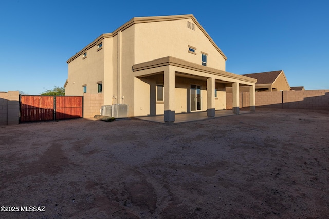 back of property with stucco siding, fence private yard, and a patio area