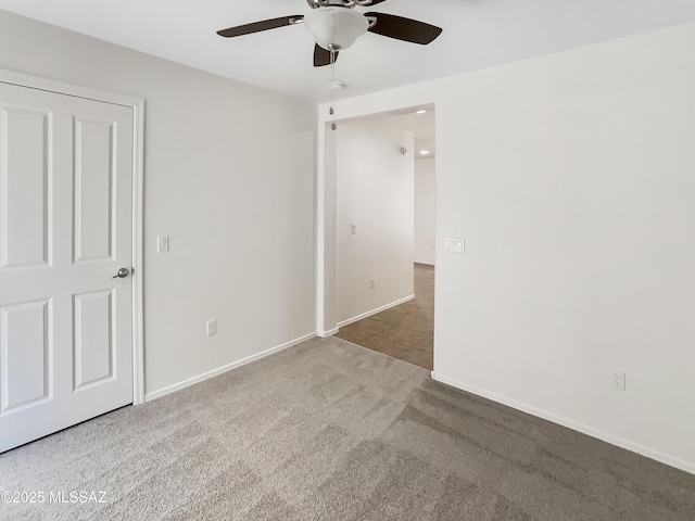 11155 E Vail Vista Ct, Tucson, AZ 85747 - unfurnished bedroom featuring tile patterned floors, a ceiling fan, carpet floors, and baseboards