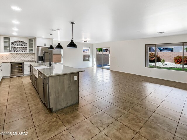 11155 E Vail Vista Ct, Tucson, AZ 85747 - kitchen with beverage cooler, backsplash, plenty of natural light, and a sink