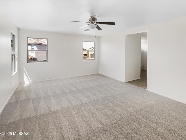 11155 E Vail Vista Ct, Tucson, AZ 85747 - carpeted empty room featuring plenty of natural light, a ceiling fan, and baseboards