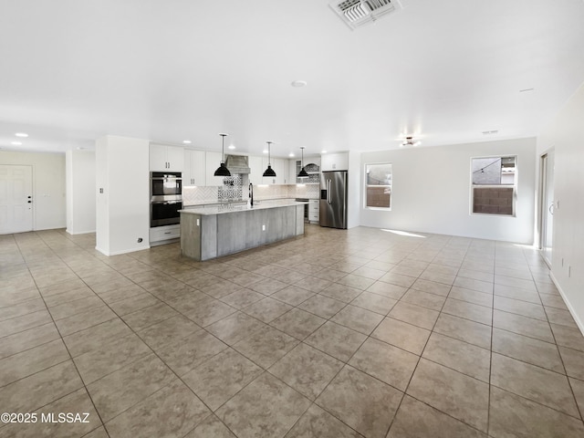 11155 E Vail Vista Ct, Tucson, AZ 85747 - kitchen with light tile patterned floors, visible vents, appliances with stainless steel finishes, and open floor plan