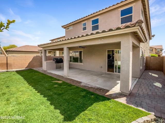 11155 E Vail Vista Ct, Tucson, AZ 85747 - back of property featuring stucco siding, a ceiling fan, a yard, and a fenced backyard