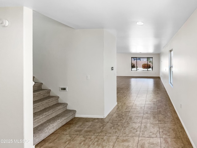 11155 E Vail Vista Ct, Tucson, AZ 85747 - interior space featuring light tile patterned floors, stairway, and baseboards